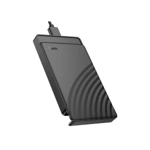 Cofre disco duro Hoco HB46 negro, vista en ángulo con base tipo soporte y relieve semicircular, cable conectado, fondo blanco y margen perimetral uniforme.